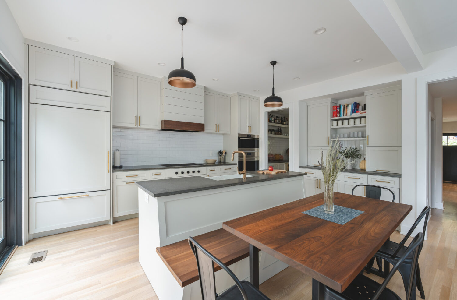 Contemporary kitchen in NW Washington, DC home renovation featuring clean lines, modern appliances, and stylish pendant lighting in a spacious layout